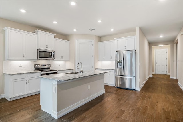 kitchen featuring white cabinetry, sink, light stone counters, and appliances with stainless steel finishes