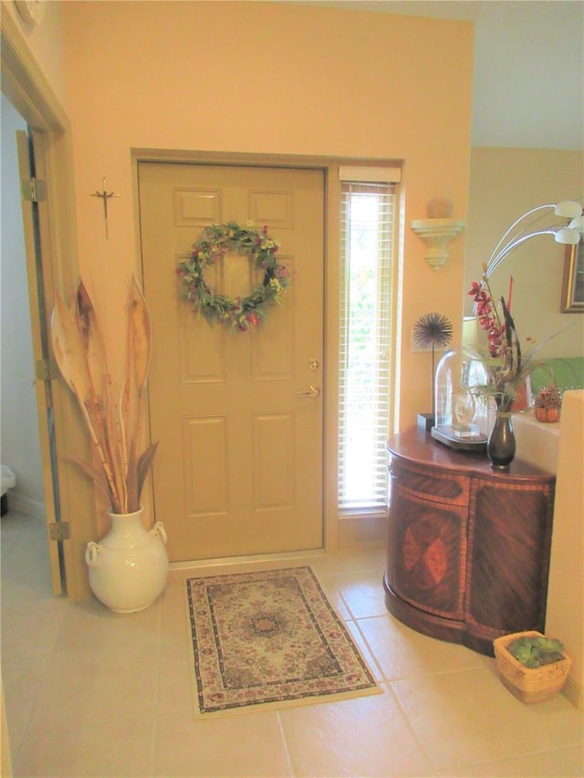 tiled foyer featuring plenty of natural light