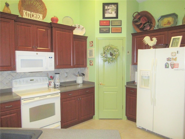 kitchen featuring white appliances, tasteful backsplash, and light tile floors