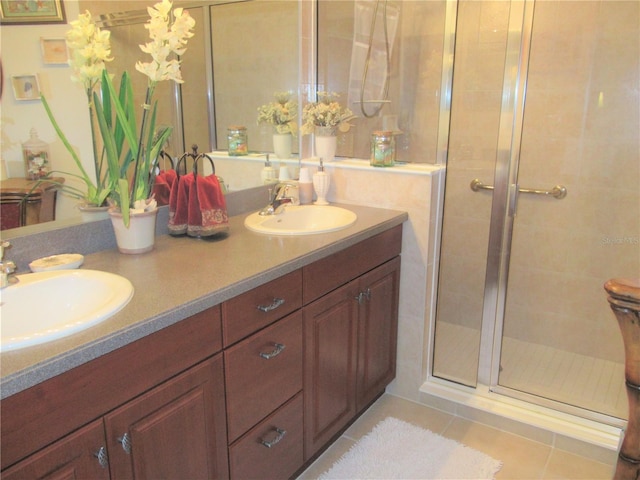 bathroom with a shower with door, tile flooring, and dual vanity