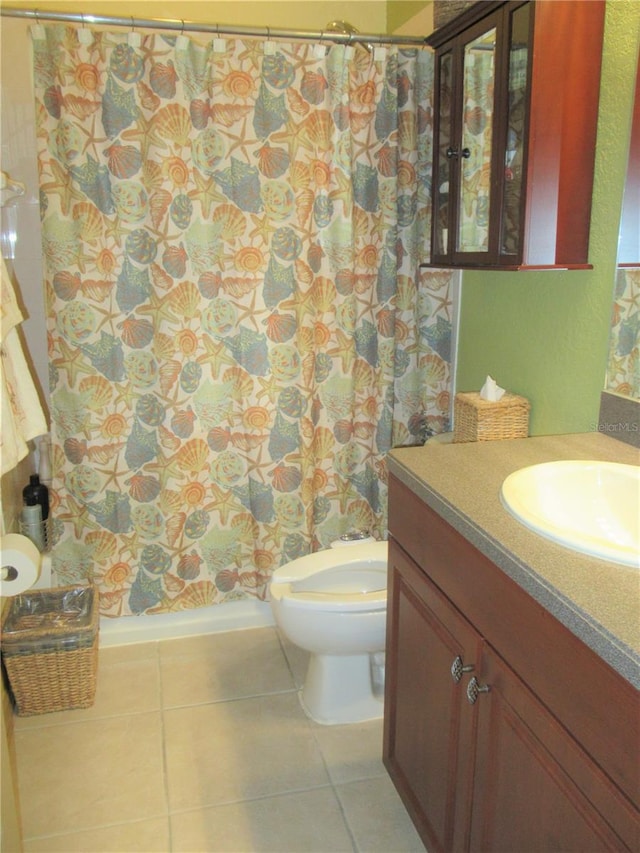 bathroom with oversized vanity, toilet, and tile flooring