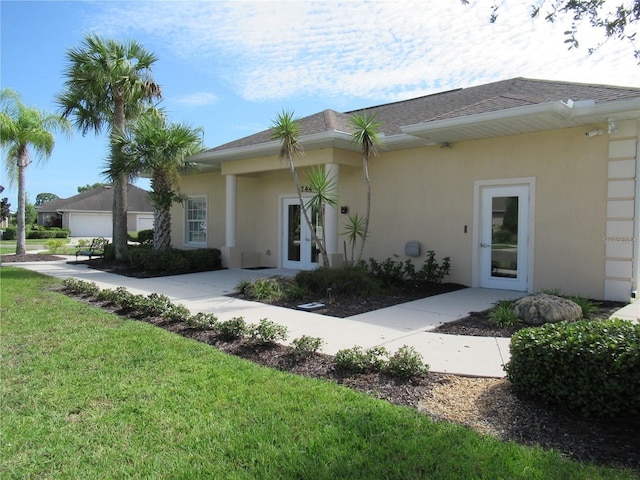 exterior space with a front yard and a garage