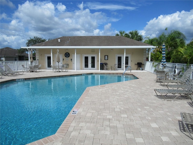 view of swimming pool with a patio area and french doors