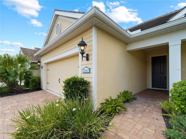 view of exterior entry with a garage