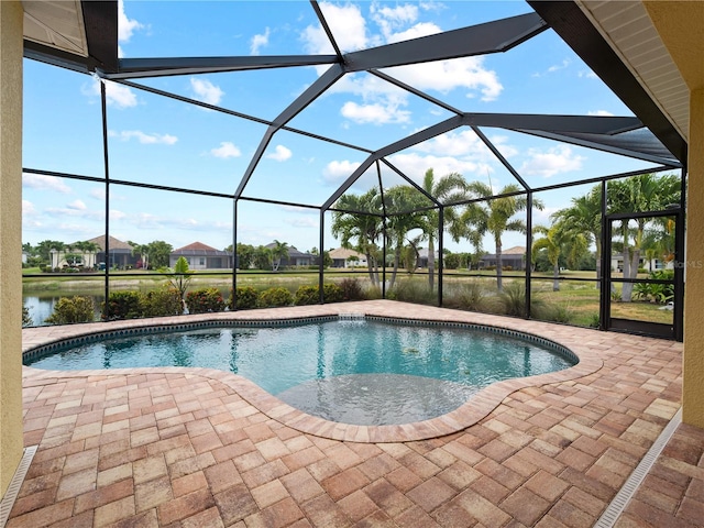 view of swimming pool with a water view, a patio area, and a lanai