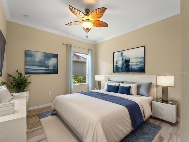 bedroom featuring ceiling fan, light hardwood / wood-style flooring, and crown molding