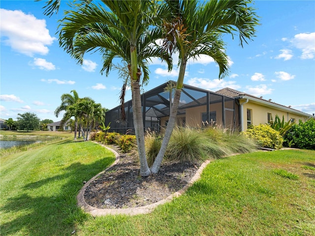 exterior space with a lanai and a water view