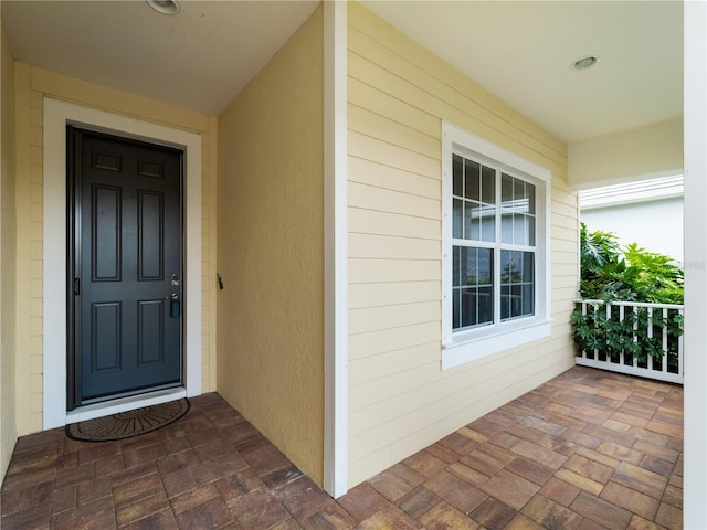 doorway to property featuring covered porch