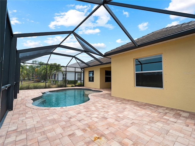 view of swimming pool with a lanai and a patio