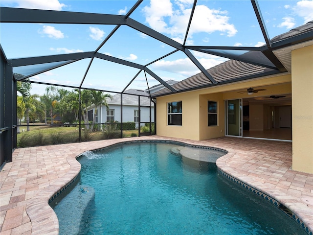 view of swimming pool with a lanai, ceiling fan, and a patio