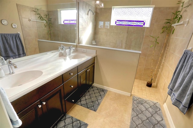 bathroom featuring tile patterned floors, vanity, and a tile shower