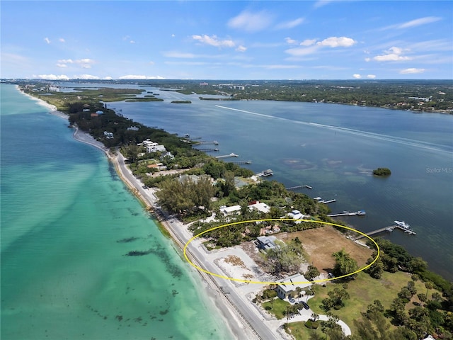 aerial view with a water view and a beach view