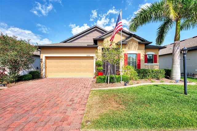 view of front of home with a garage and a front yard