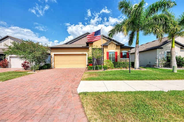 view of front of house featuring a garage and a front yard