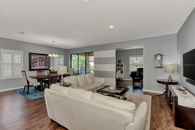 living room featuring dark hardwood / wood-style flooring and a notable chandelier