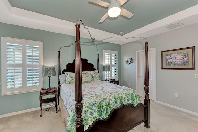 carpeted bedroom featuring ceiling fan and multiple windows