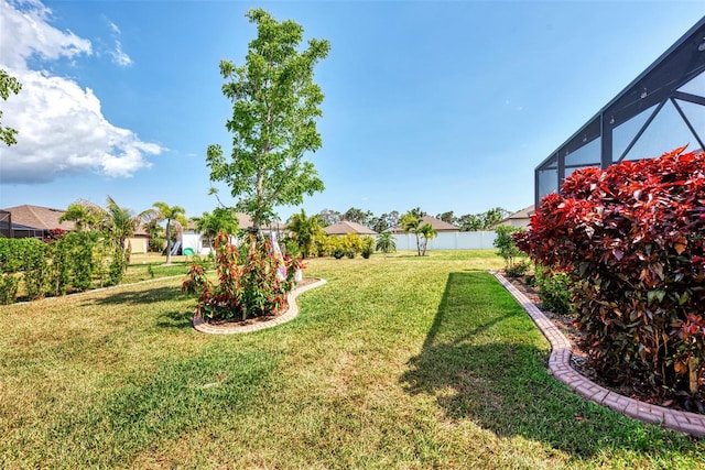 view of yard featuring a lanai