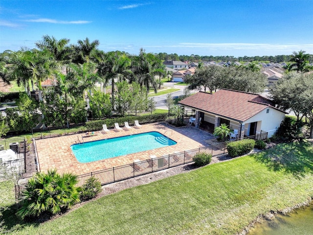 view of pool featuring a patio and a yard