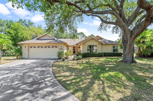 ranch-style house featuring a garage and a front yard