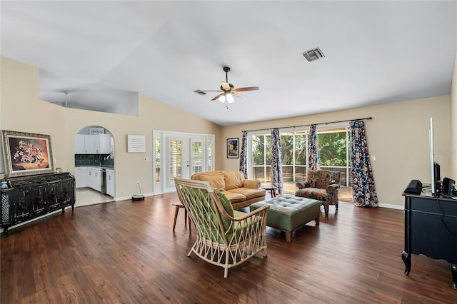 living room with dark hardwood / wood-style flooring, ceiling fan, french doors, and vaulted ceiling