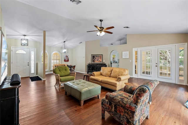 living room featuring hardwood / wood-style flooring, ceiling fan, and vaulted ceiling