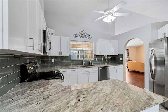 kitchen featuring appliances with stainless steel finishes, ceiling fan, sink, backsplash, and hardwood / wood-style flooring