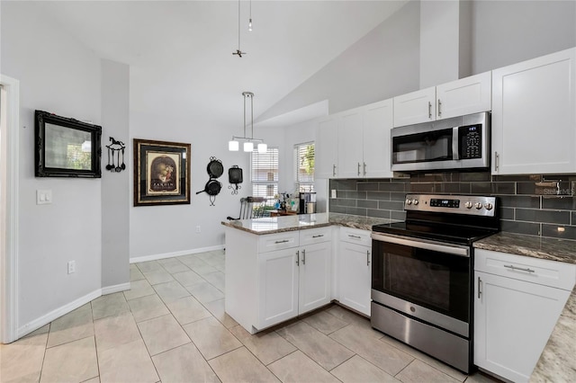 kitchen with hanging light fixtures, kitchen peninsula, stainless steel appliances, light tile floors, and tasteful backsplash