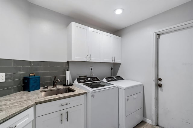 laundry area with washer and clothes dryer, hookup for an electric dryer, cabinets, and sink