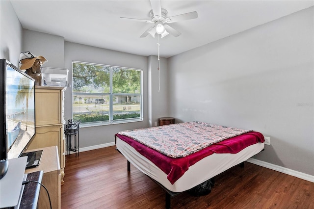 bedroom featuring ceiling fan and dark wood-type flooring