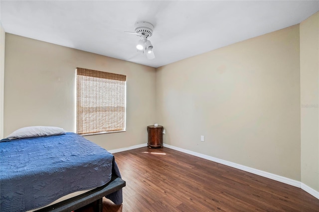 bedroom featuring ceiling fan and dark wood-type flooring