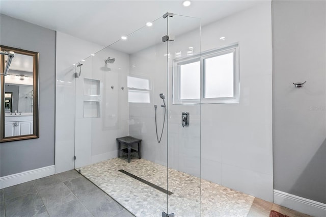 bathroom with walk in shower and tile flooring