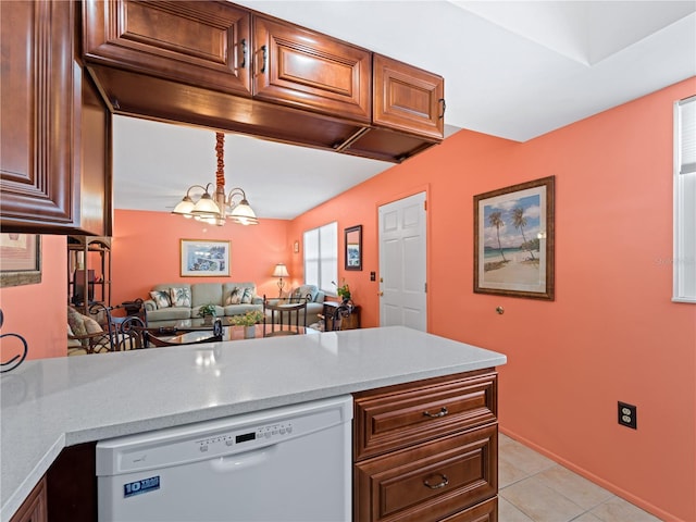 kitchen featuring a notable chandelier, light tile flooring, white dishwasher, and kitchen peninsula