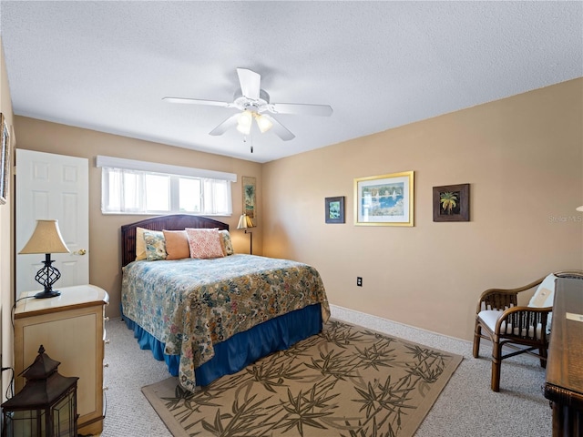 carpeted bedroom with a textured ceiling and ceiling fan