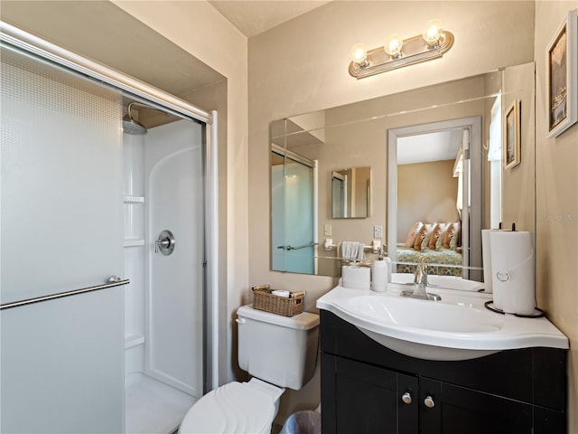 bathroom featuring an enclosed shower, large vanity, and toilet