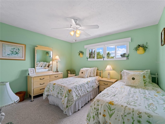 bedroom with ceiling fan, a textured ceiling, and light colored carpet