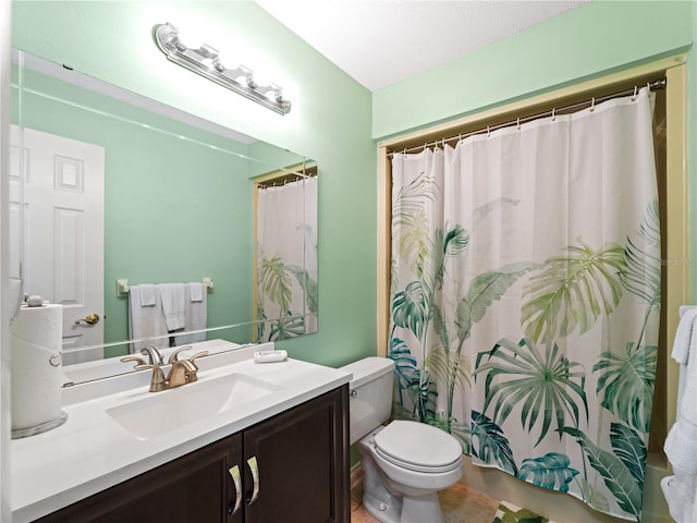 bathroom featuring tile flooring, large vanity, and toilet