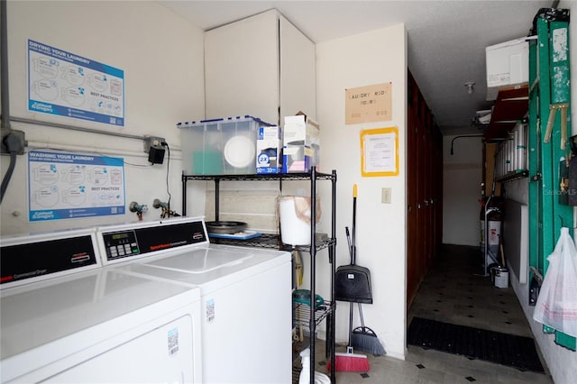 clothes washing area featuring tile flooring, washing machine and dryer, and hookup for a washing machine