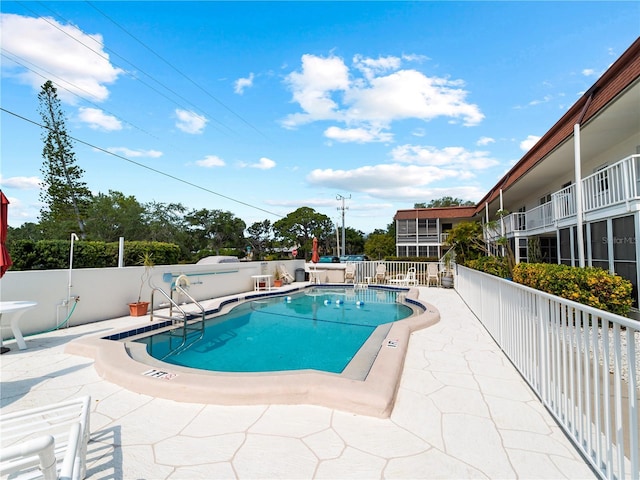 view of swimming pool with a patio area