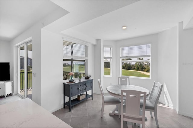 tiled dining room with plenty of natural light