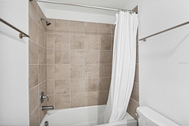 bathroom featuring toilet and shower / bath combo with shower curtain