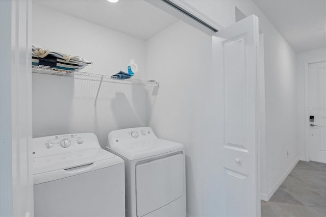 laundry room featuring washer and clothes dryer and light tile floors