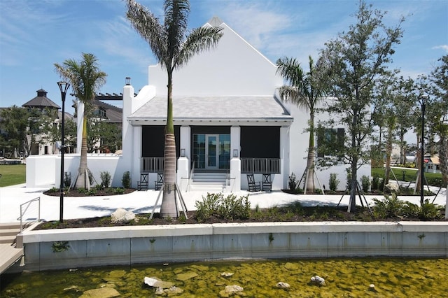 back of property featuring a porch