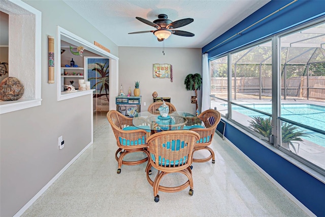 carpeted dining area with ceiling fan and a textured ceiling