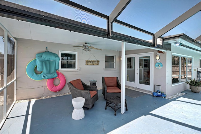 view of patio / terrace with french doors, glass enclosure, and ceiling fan