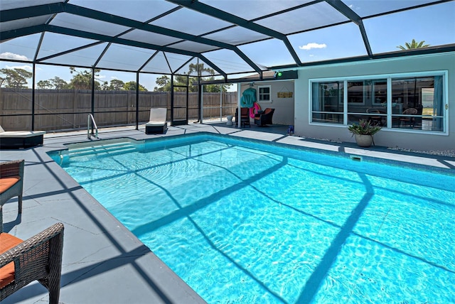 view of swimming pool featuring a lanai and a patio