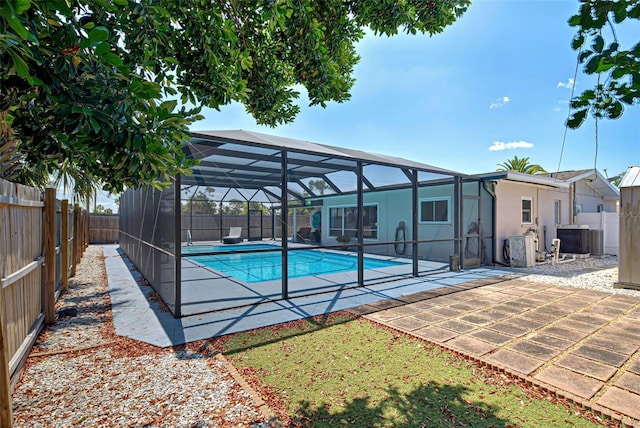 view of swimming pool with glass enclosure and central AC