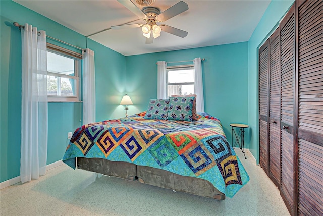 bedroom featuring ceiling fan, a closet, and carpet floors