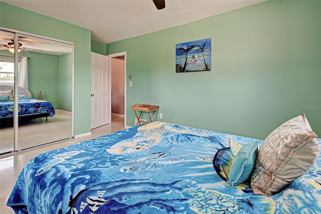 carpeted bedroom with ceiling fan and a closet