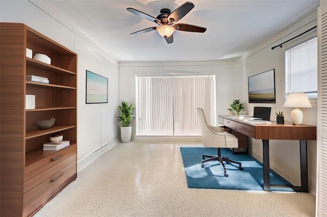 office space featuring ceiling fan and crown molding