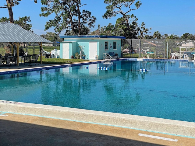 view of pool with a gazebo and an outdoor structure